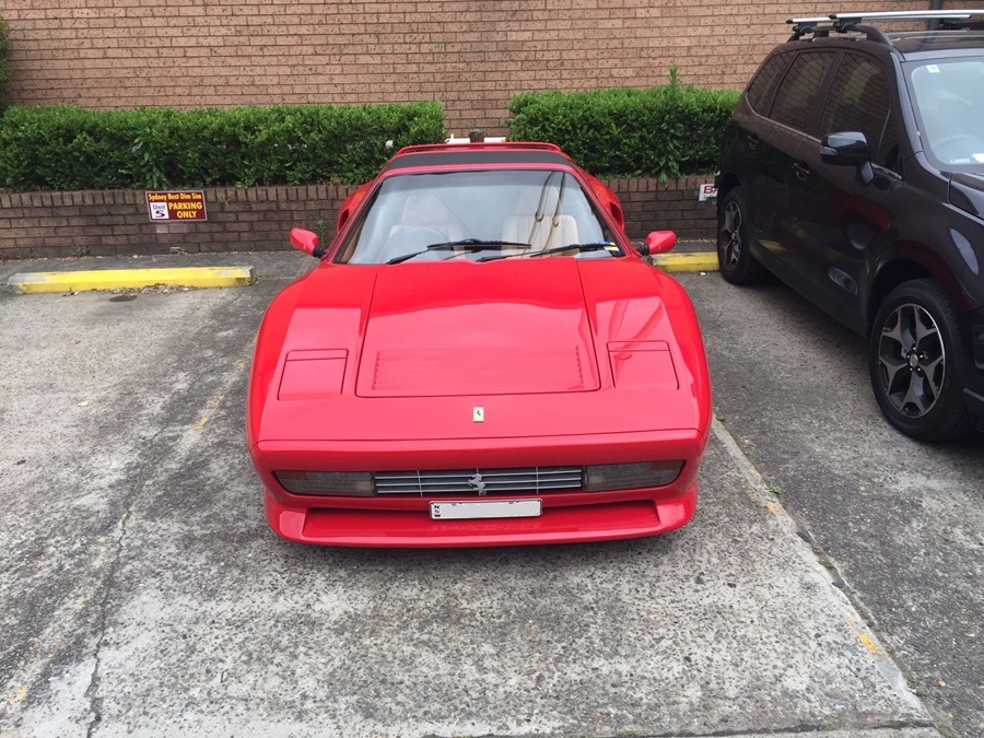 red ferrari in the yard