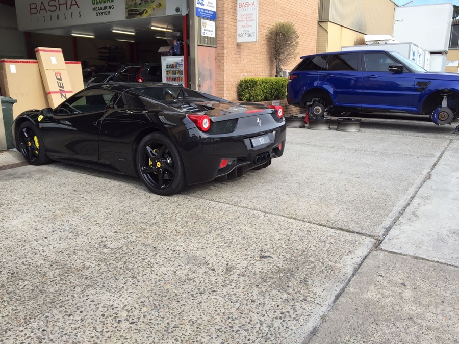 Basha Autohaus repair many Ferrari vehicles parked black ferrari