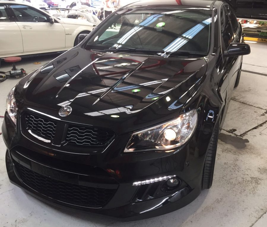 shiny black car detailed to make it sparkle